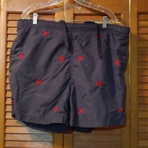 Swimming trunks with red woven lobsters